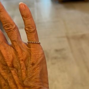 14k gold eternity band with moissanite stones completely around.